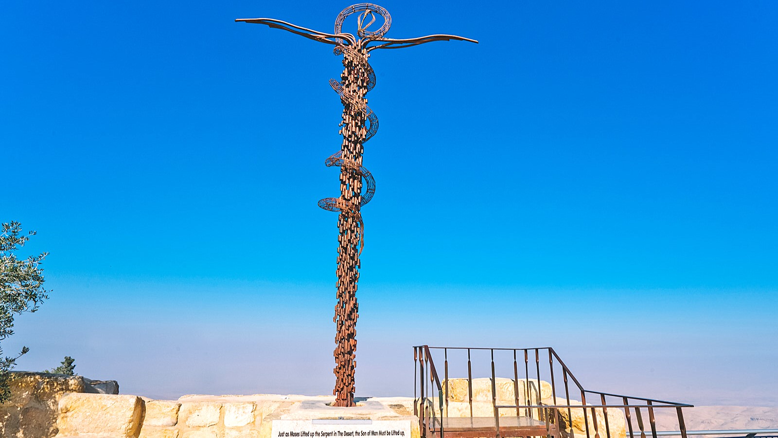 Panoramic view from Mount Nebo in Jordan, overlooking the Jordan Valley, Dead Sea, and Jerusalem, with ancient ruins and mosaics.